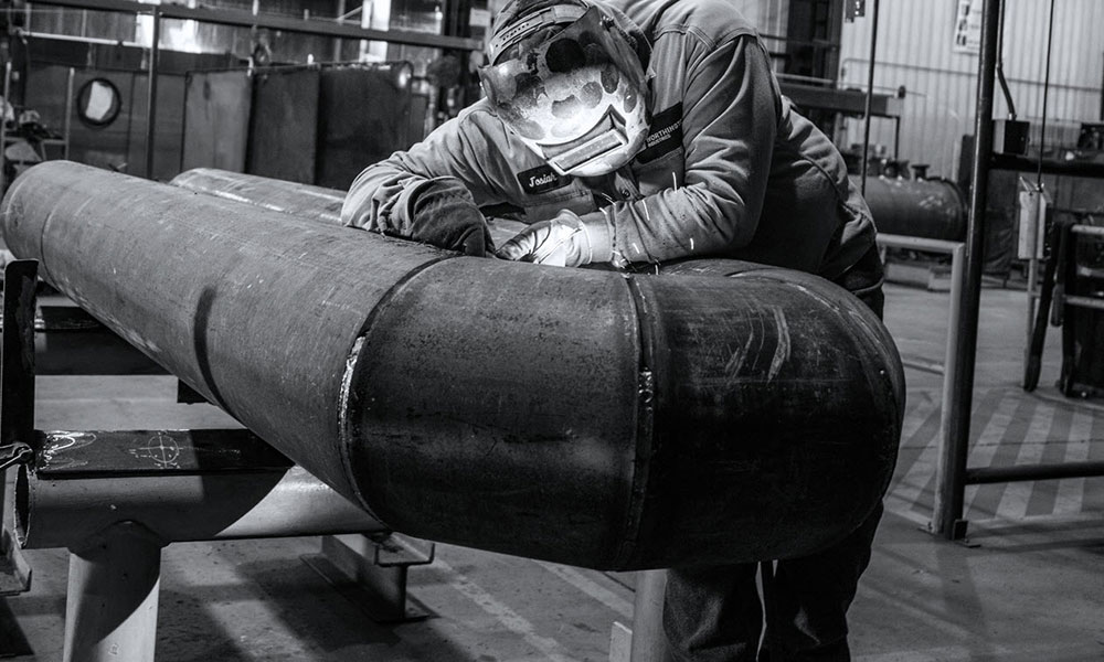 Person welding large pipe